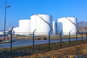 white tank in tank farm with blue sky
