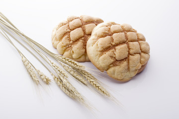 japanese sweet roll and wheat on white background