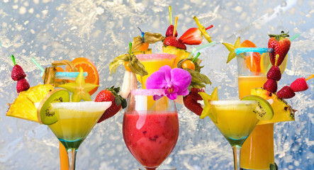 Different cocktails and smoothies decorated with fruits