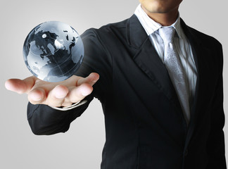 holding a glowing earth globe in his hands