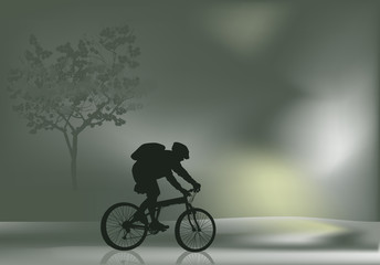 Fototapeta na wymiar cyclist silhouette in mist landscape