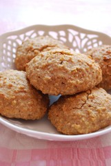 Homemade almonds cookies in white tray on pink background