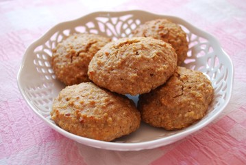 Homemade almonds cookies in white tray on pink background