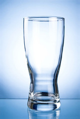 Empty glass glass for drinks on a blue background