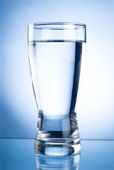 Glass of water on a blue background