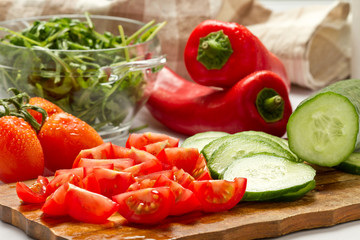 Cut vegetables, salad ingredients on wood board