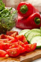 Cut vegetables, salad ingredients on wood board