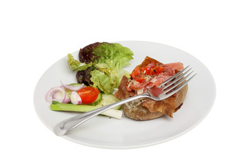 Baked potato fork and salad