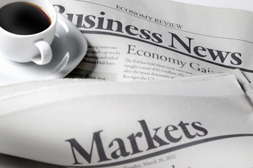 Business and markets newspapers and a cup of coffee