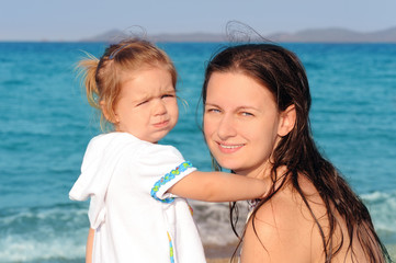 Fototapeta na wymiar Happy child with her mother on the beach