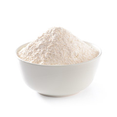 Whole flour pile or heap in seramic bowl isolated on white background