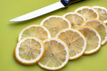 Sliced lemon on the green board