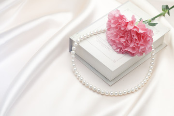 Pearl necklace and Carnation