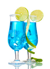 Blue cocktail in glasses with ice and sugar isolated on white