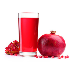 ripe pomergranate and glass of juice isolated on white.