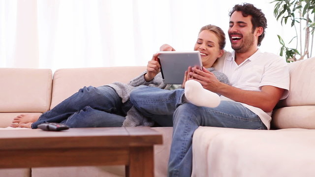 Young couple holding a tablet computer