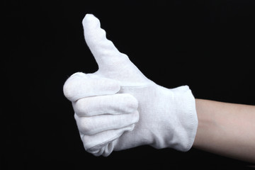 cloth glove on hand on black background.