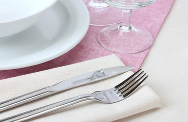 Table setting with fork, knife, plates and napkin