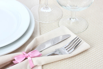 Table setting with fork, knife, plates, and napkin