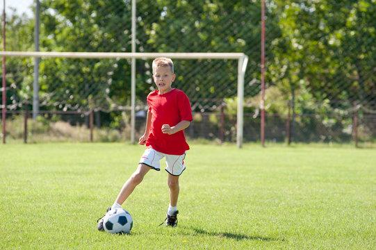 Child playing soccer ball