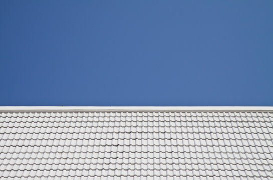 White roof on blue sky background.