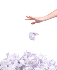 stack of crumpled paper balls and hand isolated on white