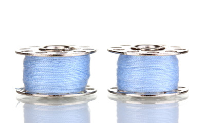 Metal spools of thread isolated on white