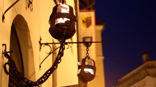 Evening fire burns in an old street lamp