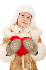 Girl in warm clothing holding the heart in his hands