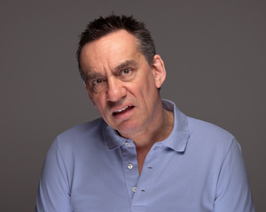 Obraz premium Middle Age Man Pulling Unhappy Face and Grimacing