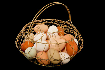 Fototapeta na wymiar Eggs in old Wire Basket