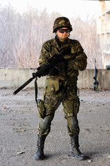 Fototapeta premium Military guy holding a gun