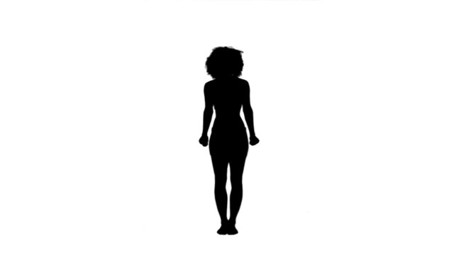 Silhouette of a woman raising her arms