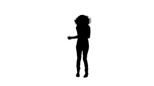 Silhouette of woman with a microphone dancing