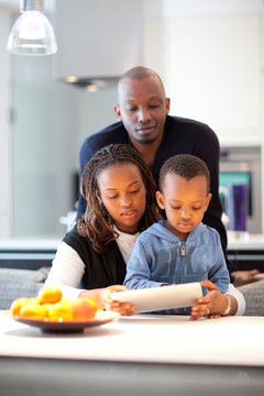 Young black family in fresh modern kitchen