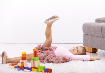 Little ballerina posing on floor