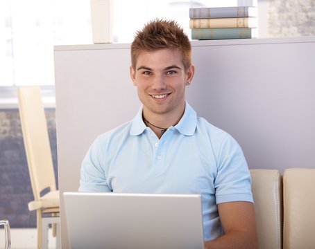 Happy young man with computer