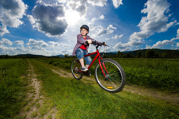 Naklejka na ściany i meble Cyclist - boy riding bike