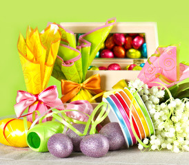 colorful easter decoration. eggs and flowers on green