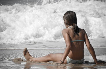 assise dans l'écume des vagues