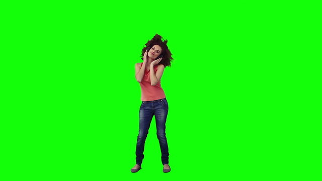A woman wearing headphones is dancing