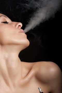 Woman smokes a hookah
