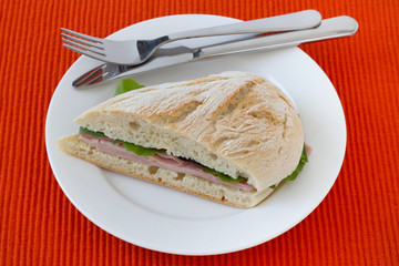 sandwich with ham and lettuce on the plate