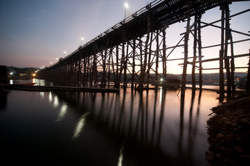 The long wood bridge in sunset , Kanchanaburi province in Middll
