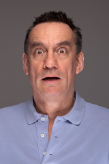 Portrait of Shocked Scared Middle Age Man on Grey Background