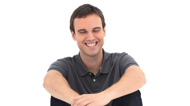 Smiling man sitting on the floor