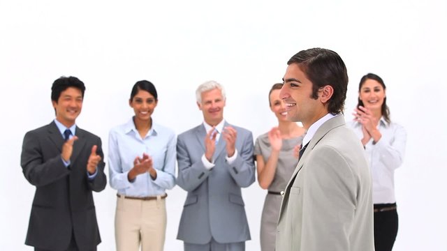 Man being congratulated by his co-workers