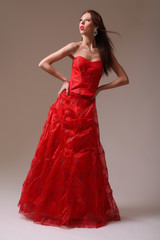 Young fashion model in red dress