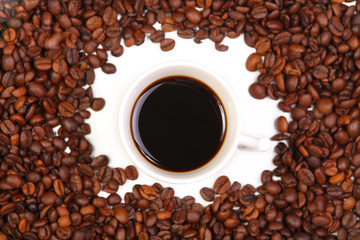 Cup with coffee. costing on coffee grain