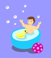 Little boy having a bath with a toy duck.